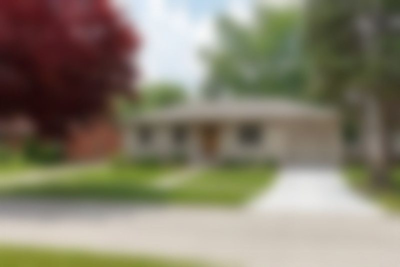 A blurred house, shown for illustration only.